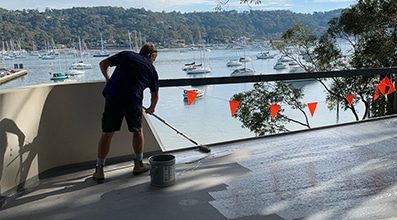 A Man Waterproofing the Balcony — Internal Waterproofing in Hornsby, NSW
